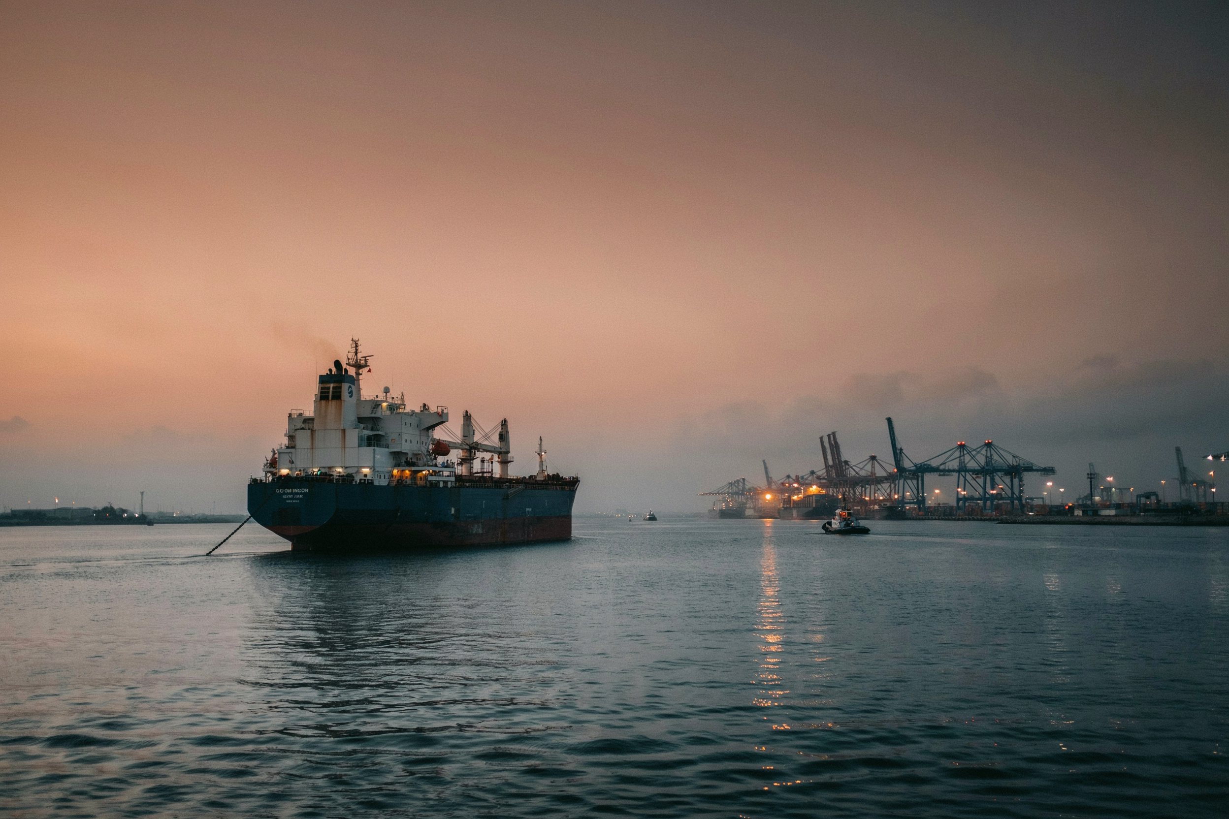 Bulk carrier waiting outside a port at dusk